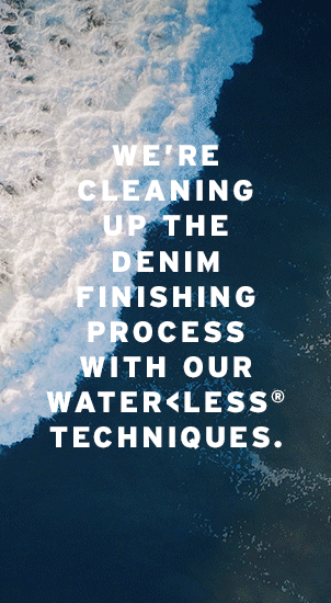 Image Description: The image background is an animation of a wave crashing on the shore of a beach. The colours are a mix of blues and white. There is white text that reads: 'We're cleaning up the denim finishing process with our Water<Less Techniques.'